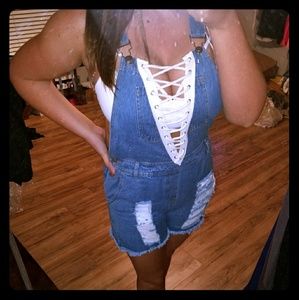 Distressed denim overalls